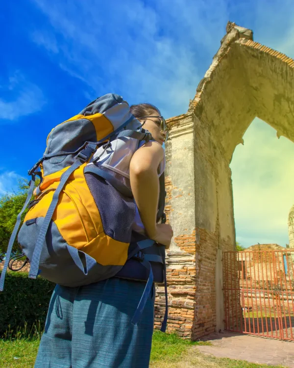 a-young-woman-walks-by-a-backpacker-in-ayutthaya-p-2026-03-26-05-09-53-utc